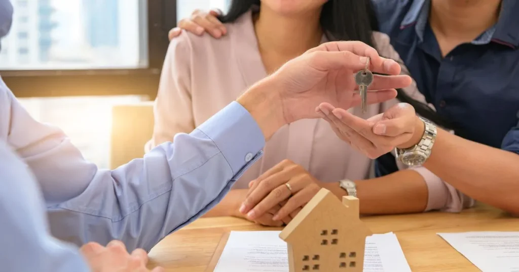 A married couple receiving the keys to a home they purchased.